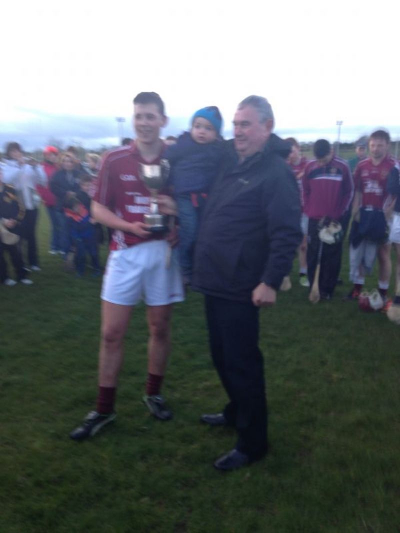 A proud Mally Darragh and Grandson John Óg present the Darragh Cup to Ruairí Óg Captain Cormac Mc Alister