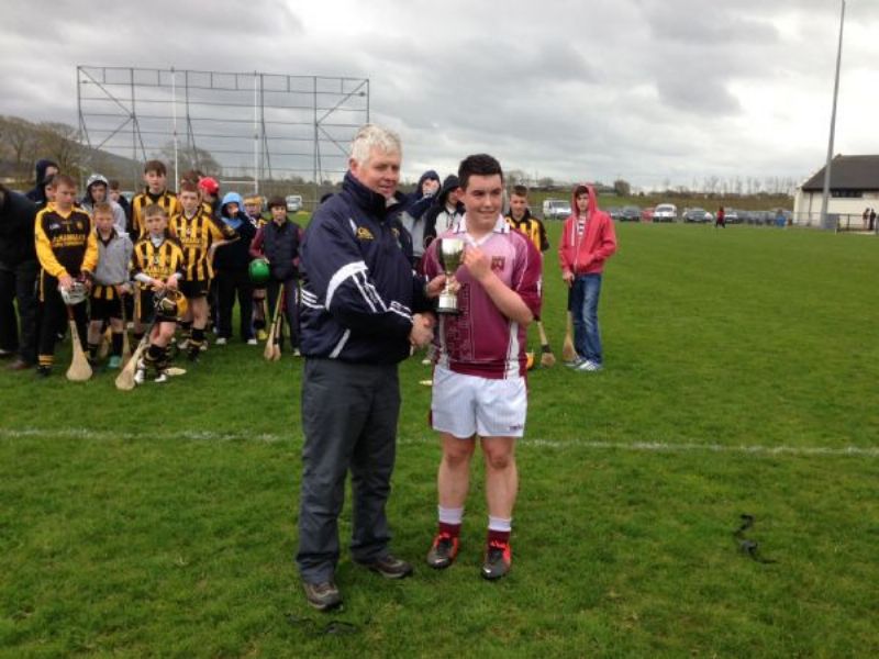 Ruairí Óg Captain Eoin Magee collects the Cup